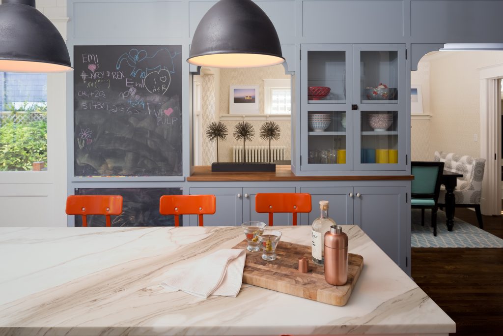 Fearless Style Fit for a Family, Kitchen featuring colorful orange bar stools, black pendant lighting, chalk board paint, chalk board wall, blue kitchen cabinets, painted kitchen cabinets, modern coastal style family home