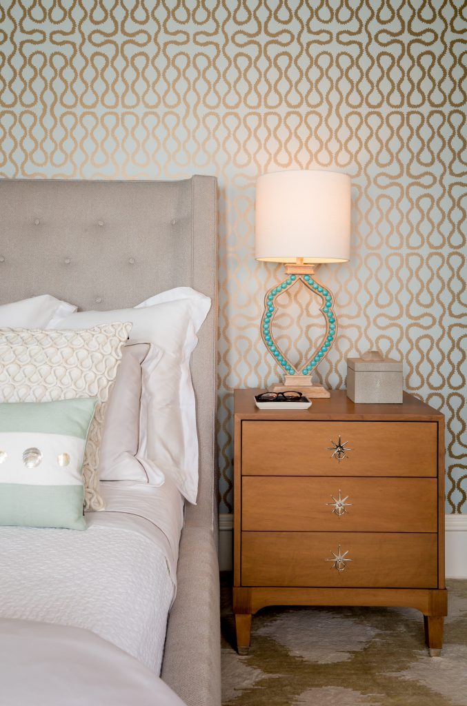 Fearless Style Fit for a Family, Master Bedroom featuring geometric and classic wallpaper, blue metallic wallcovering, white beaded chandelier, jewel box style master bedroom, circle accented mirror, coastal style family home