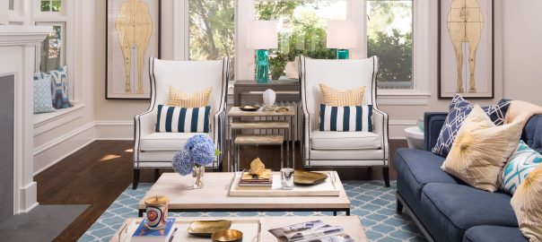 Fearless Style Fit for a Family, Living Room featuring navy blue stripped armchairs, geometric blue rug, circle mirror, gold accented artwork, horse inspired artwork, coastal style family home, coffee table styling