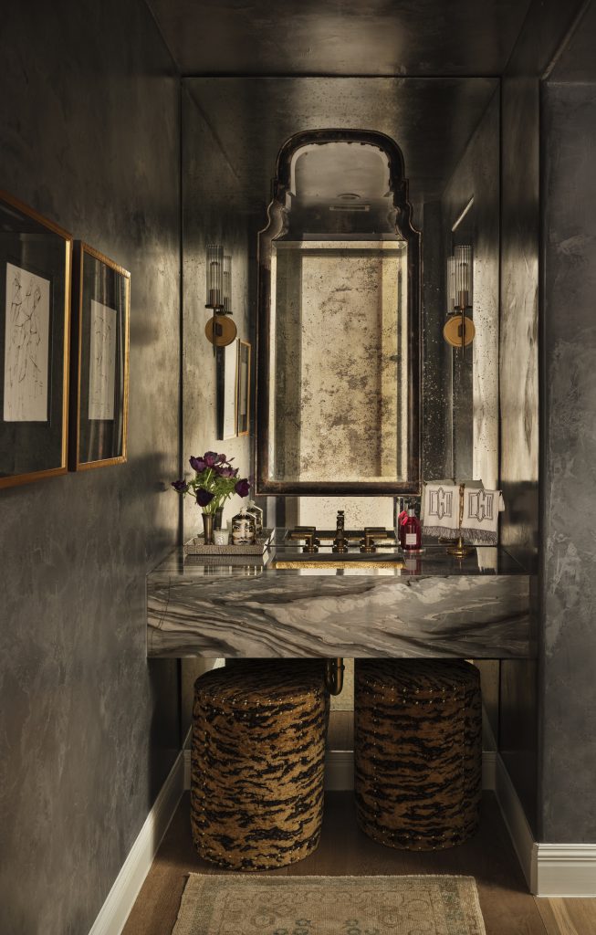 Luxury powder bathroom with dramatic stone and designer lighting.